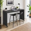 Rolling overbed table with laptop in bedroom