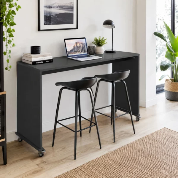 Rolling overbed table with laptop in bedroom