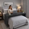 BedBridge mobile over-bed desk on wheels and guard rails used across bed - Midnight